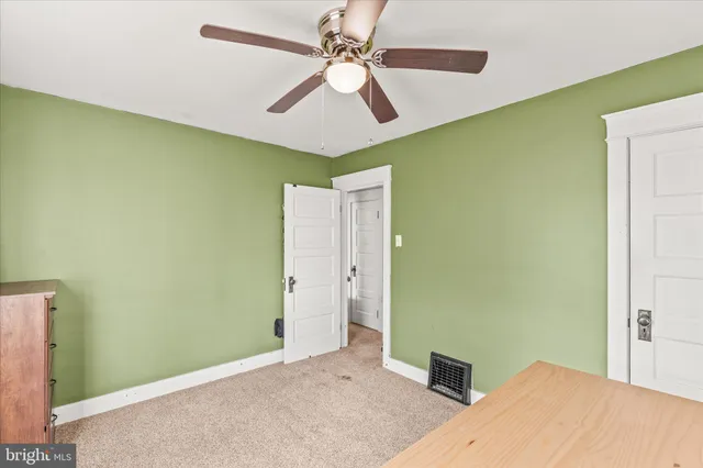a bedroom with a bed and a ceiling fan