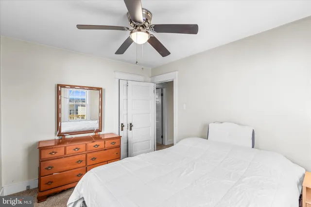 a bedroom with a bed and a dresser