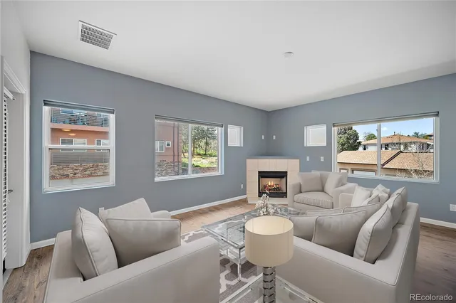 an empty room with windows and fireplace