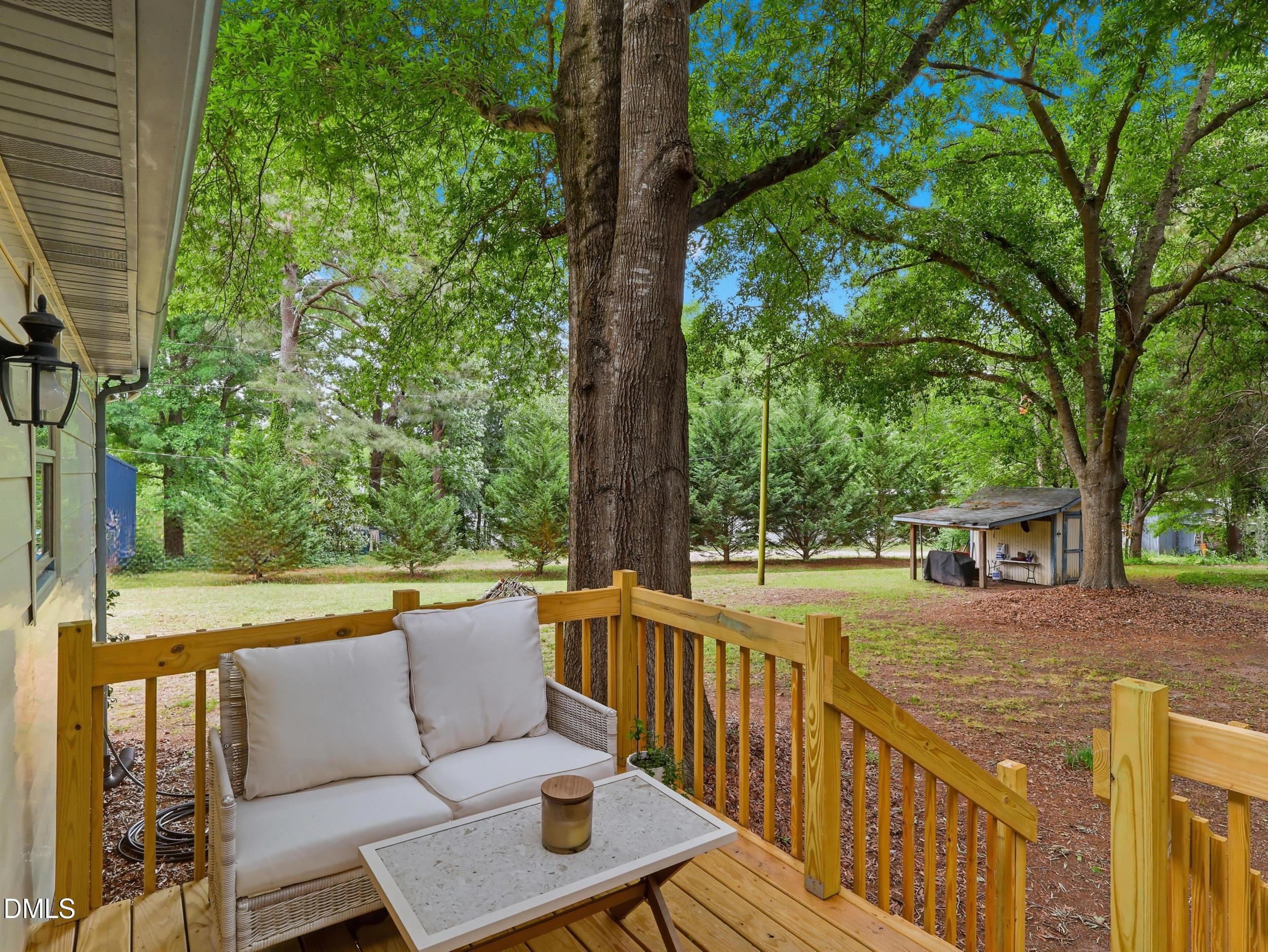 517 Lake Glad Road Wendell, NC 27591 - Photo 24 of 36 a view of a patio with couches table and chairs and wooden fence