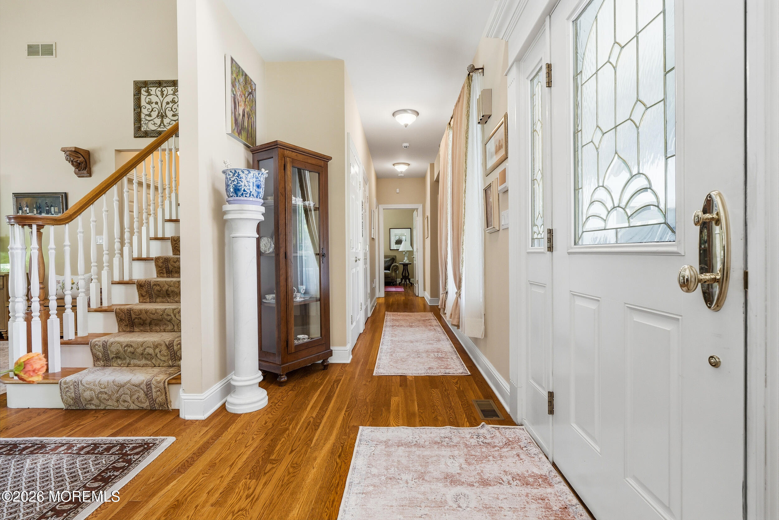 478 Rickey Lane Long Branch, NJ 07740 - Photo 21 of 64 a view of a hallway with wooden floor and staircase