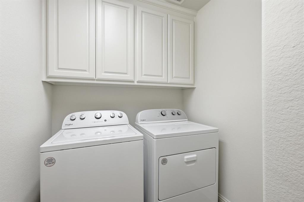 516 Sandy Lane Flower Mound, TX 75022 - Photo 21 of 38 Dedicated laundry space featuring white cabinetry and appliances