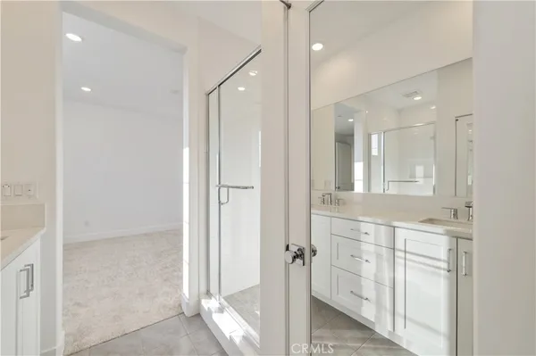 a bathroom with a glass shower door and a sink