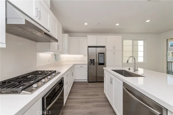 a kitchen with refrigerator and stove