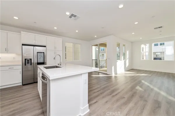 a kitchen with a refrigerator a sink and a oven