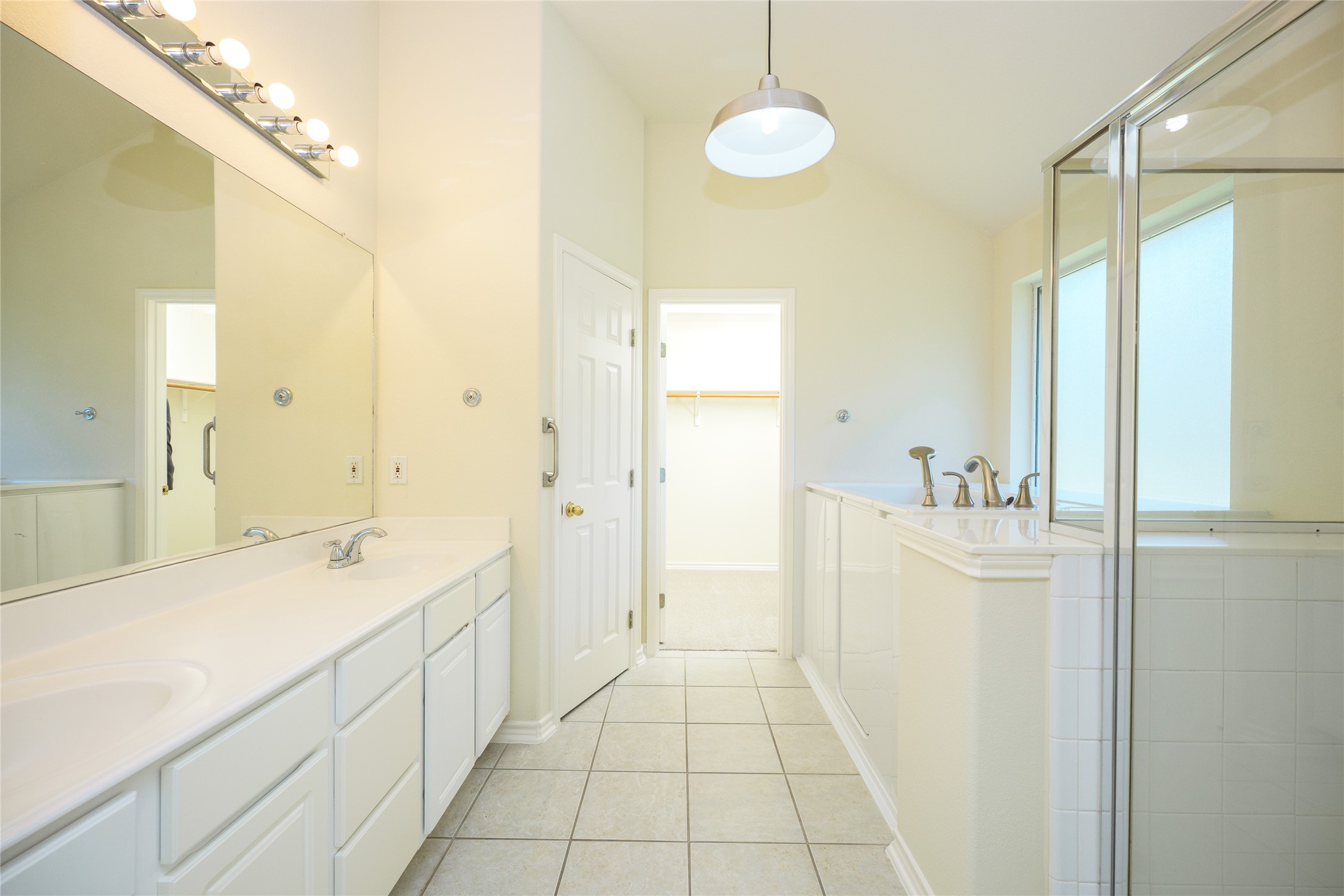 111 Arrowhead Lane Georgetown, TX 78628 - Photo 27 of 40 a spacious bathroom with a double vanity sink a mirror and a bathtub