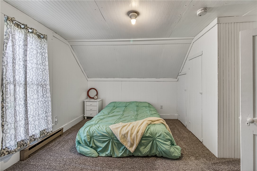 8700 Quaker Trace Road Camden, OH 45311 - Photo 21 of 34 This cozy bedroom features a sloped ceiling, providing a unique architectural detail and a comfortable retreat.