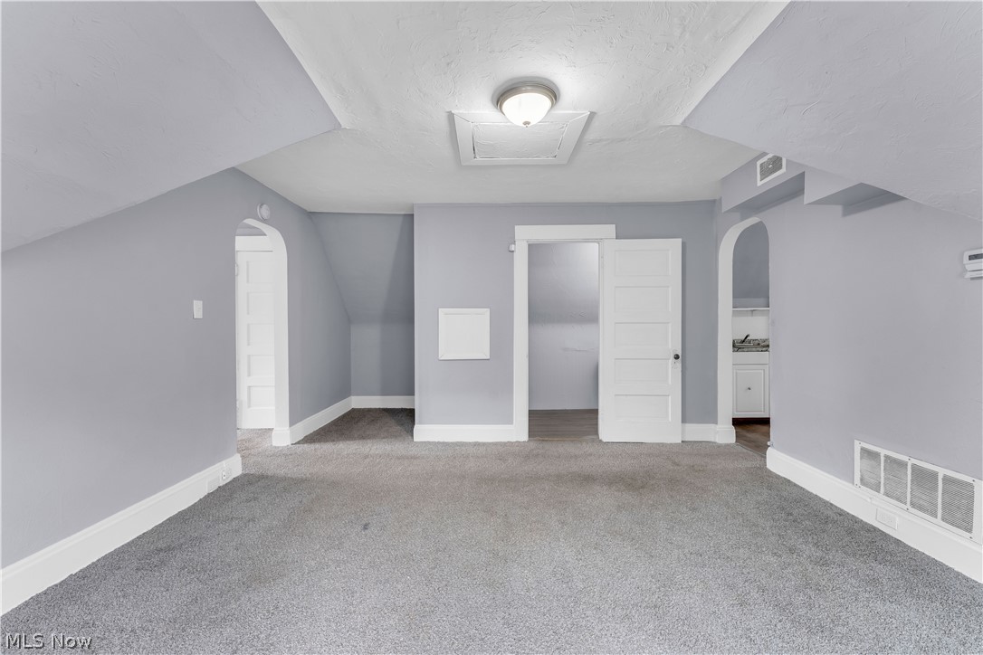13609 Blenheim Road Cleveland, OH 44110 - Photo 20 of 20 Additional living space with vaulted ceiling and carpet