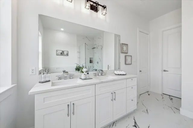 a bathroom with double sink and a mirror