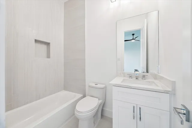 a bathroom with a toilet a sink and bathtub