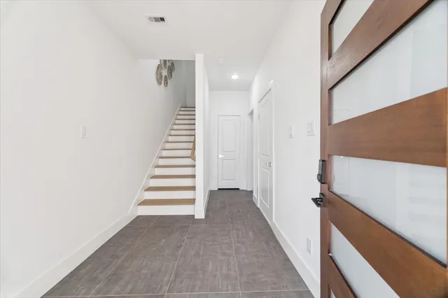 a view of a hallway with stairs