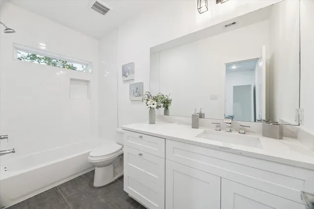 a bathroom with a sink a toilet and bathtub
