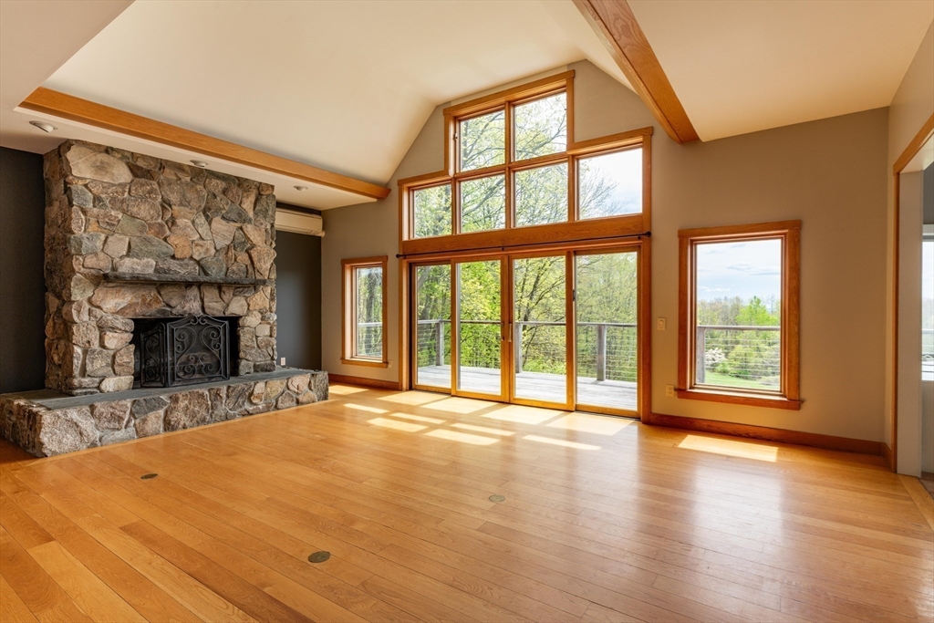 184 W Road Bernardston, MA 01337 - Photo 13 of 41 a view of an empty room with a fireplace and a window