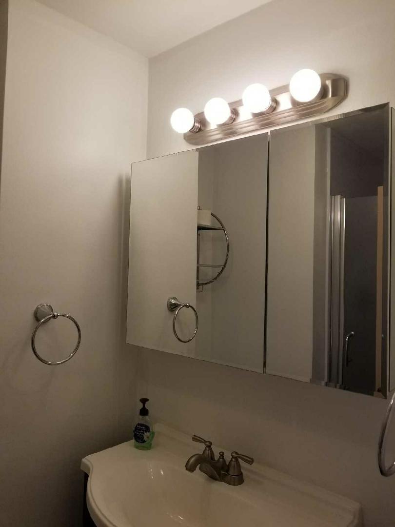 6301 North Sheridan Road, Unit 11B Chicago, IL 60660 - Photo 4 of 7 a bathroom with a sink vanity and mirror