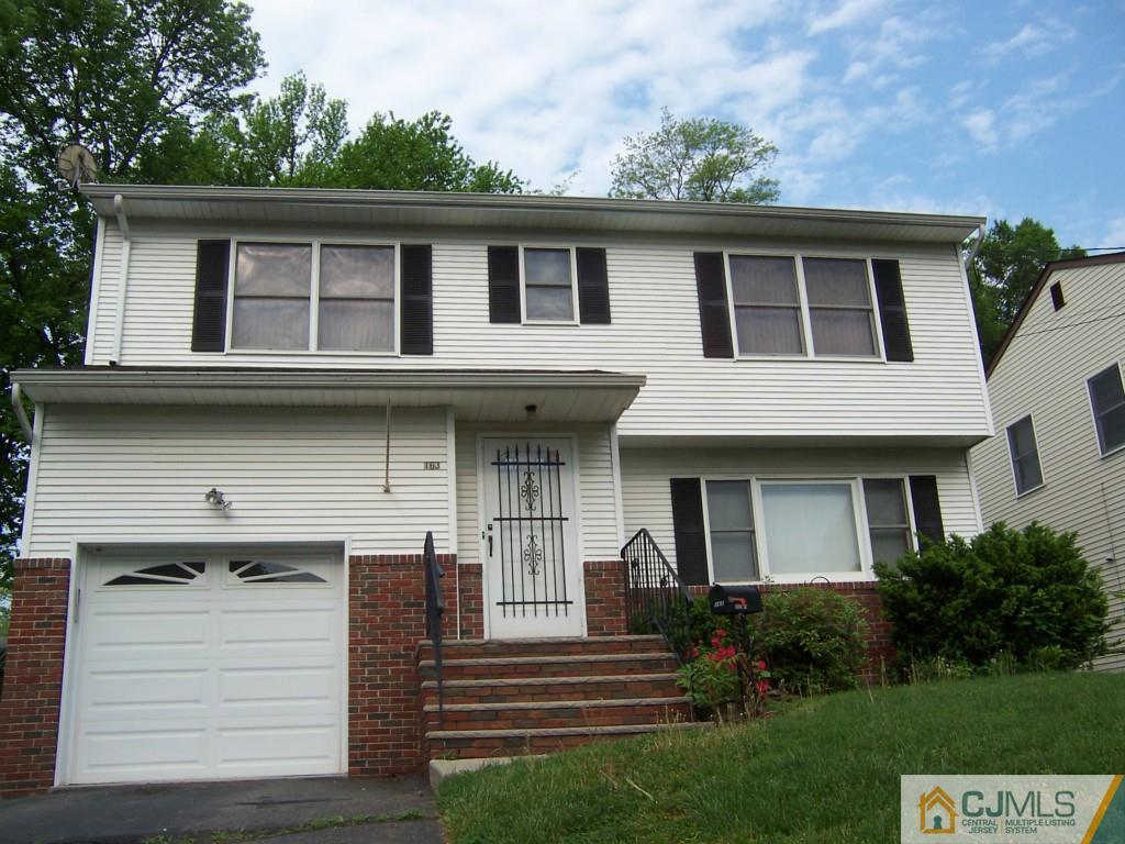 163 Kimberly Road Colonia, NJ 07067 - Photo 1 of 22 a front view of a house with a garden