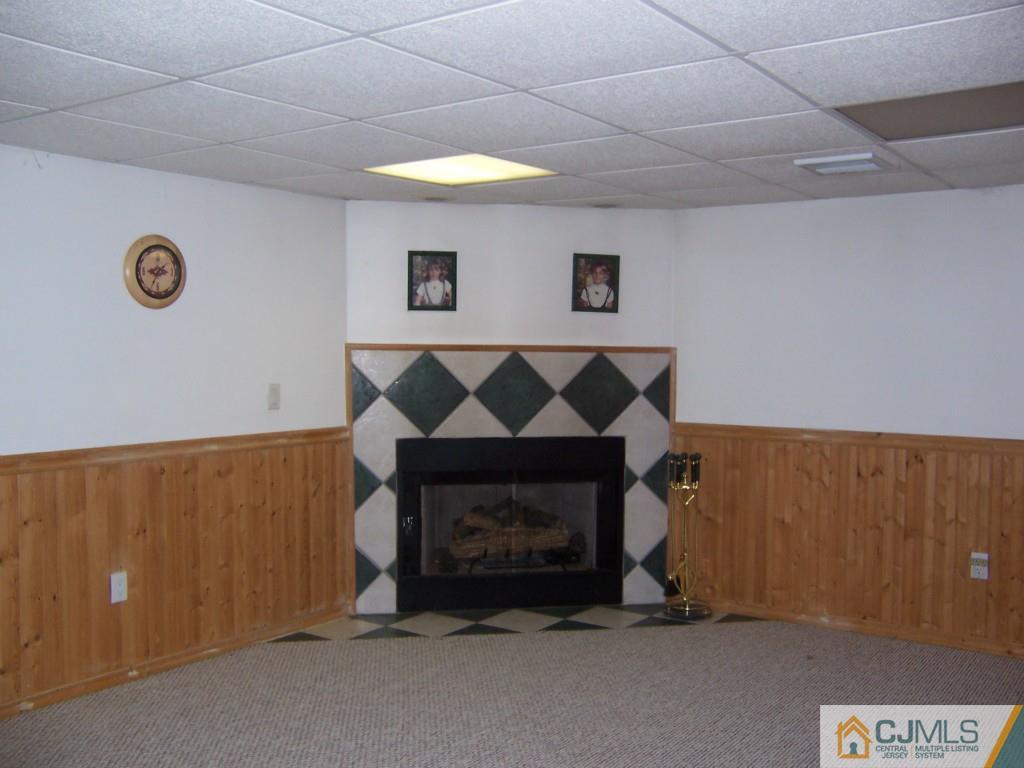 163 Kimberly Road Colonia, NJ 07067 - Photo 17 of 22 a room with a fireplace and a desk