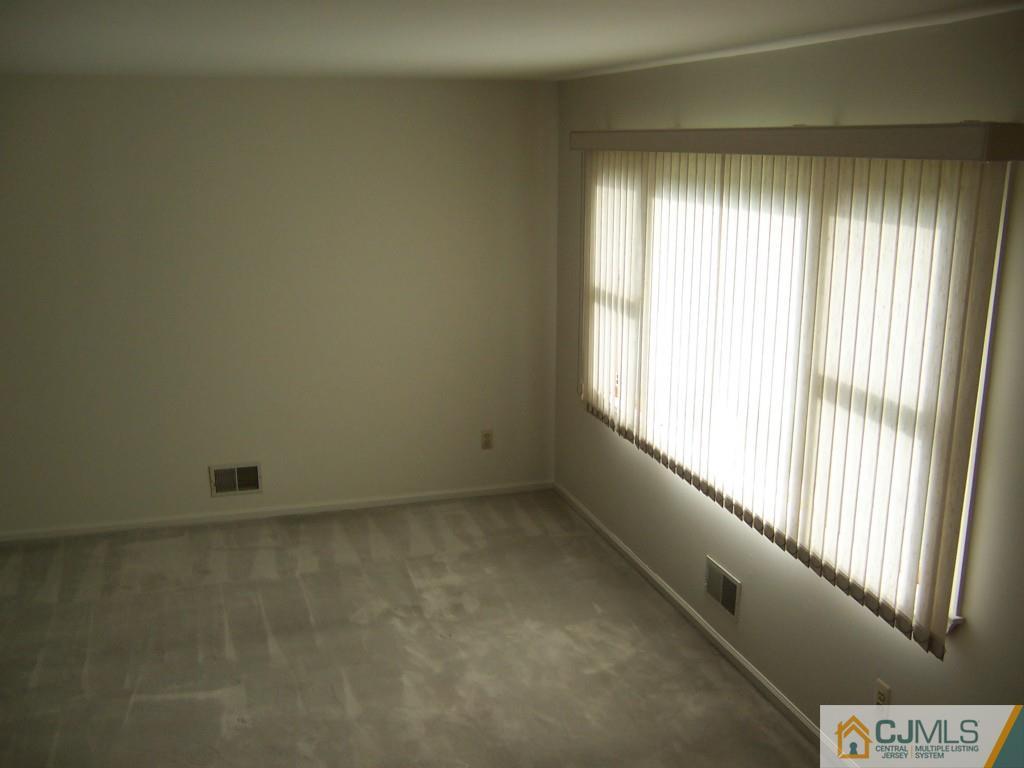 163 Kimberly Road Colonia, NJ 07067 - Photo 6 of 22 an empty room with windows