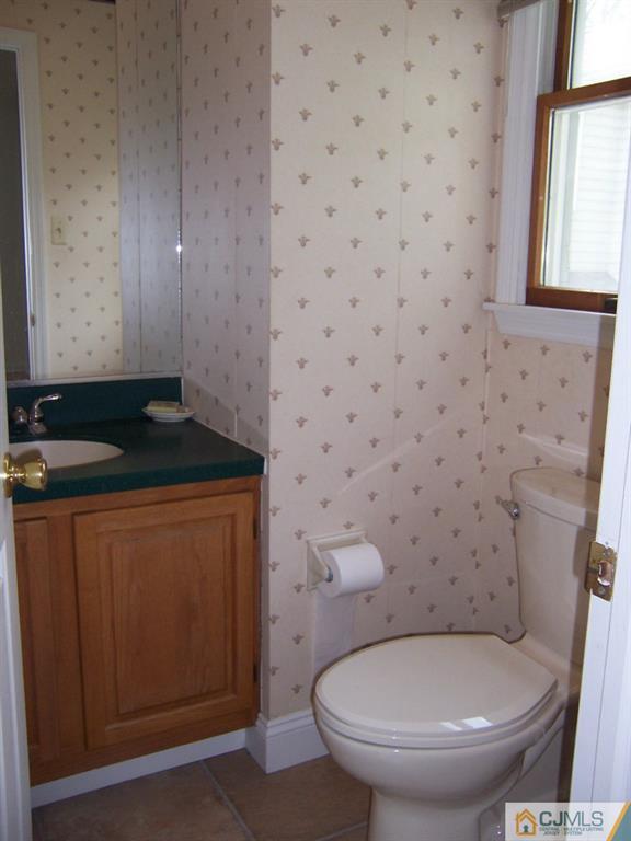 163 Kimberly Road Colonia, NJ 07067 - Photo 9 of 22 a bathroom with a toilet and a sink