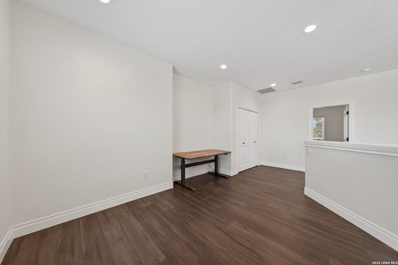 616 Crossman Fischer, TX 78623 - Photo 21 of 48 a view of an empty room with wooden floor and a window