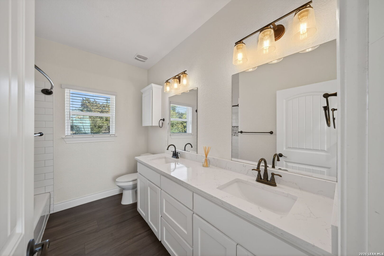 616 Crossman Fischer, TX 78623 - Photo 24 of 48 a bathroom with a double vanity sink and mirror