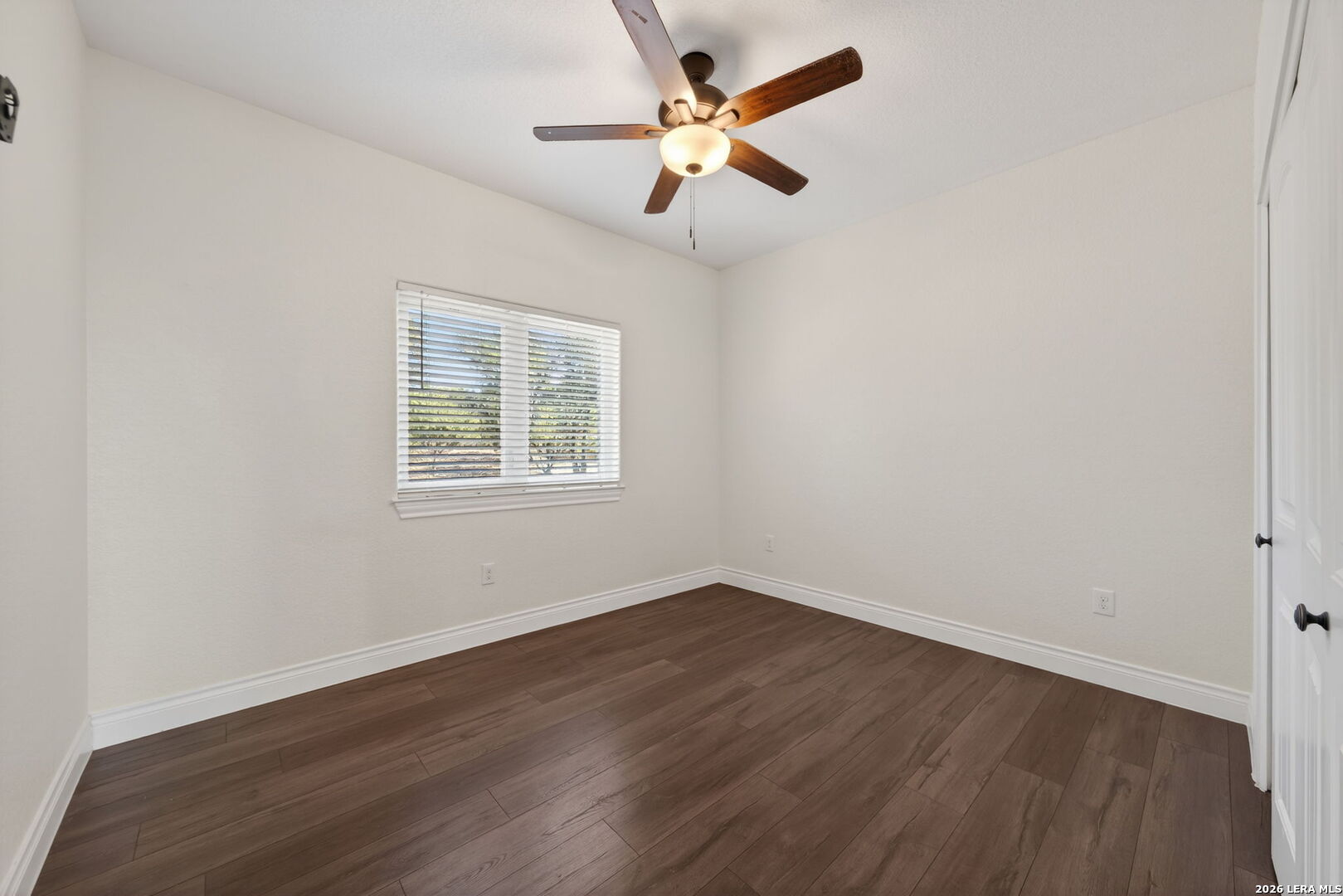 616 Crossman Fischer, TX 78623 - Photo 25 of 48 an empty room with wooden floor ceiling fan and window
