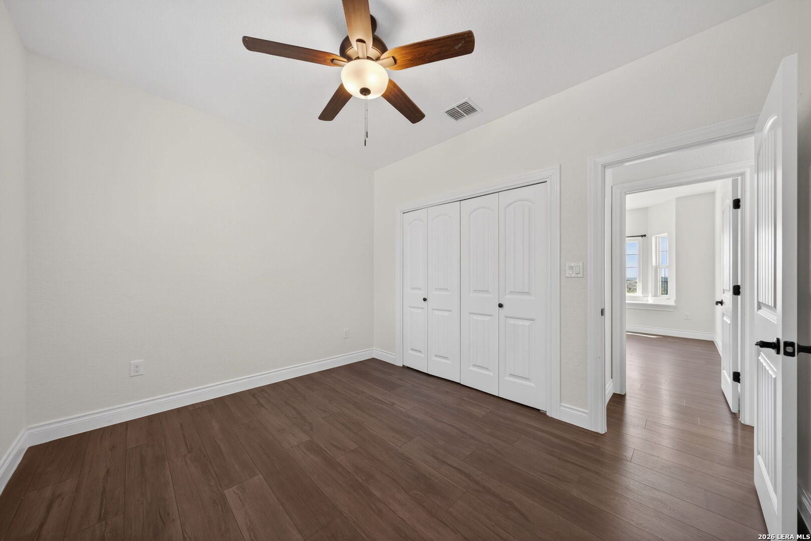 616 Crossman Fischer, TX 78623 - Photo 26 of 48 an empty room with wooden floor ceiling fan and windows