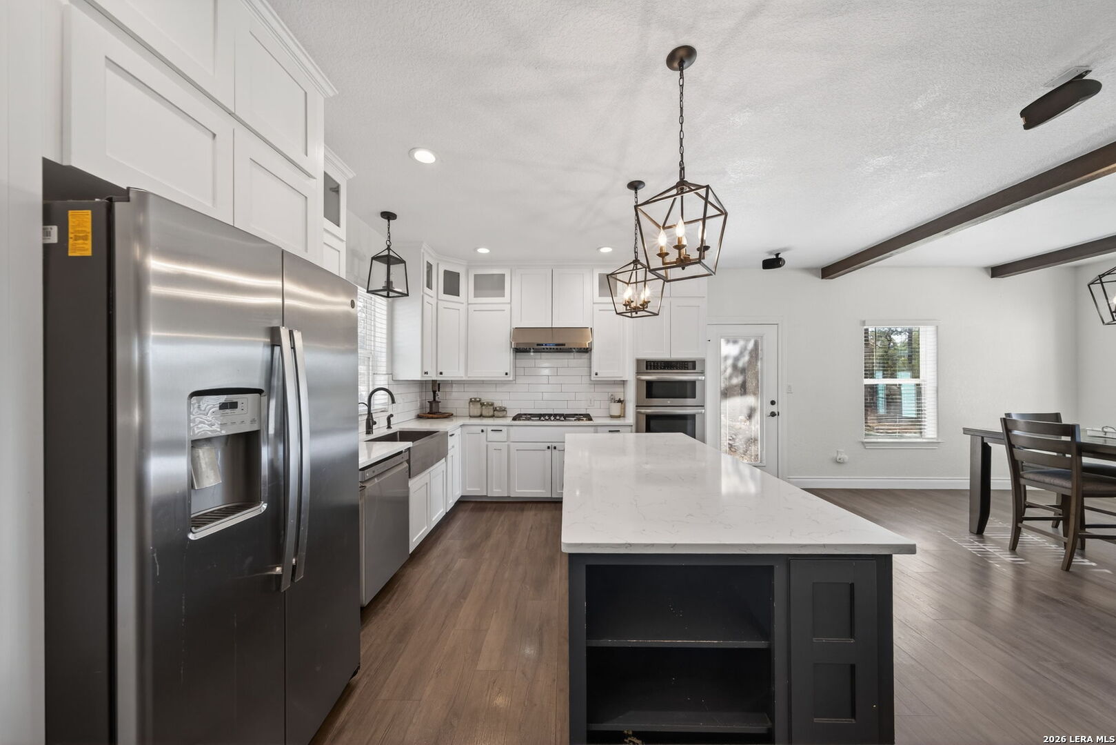 616 Crossman Fischer, TX 78623 - Photo 10 of 48 a kitchen with refrigerator cabinets dining table and chairs