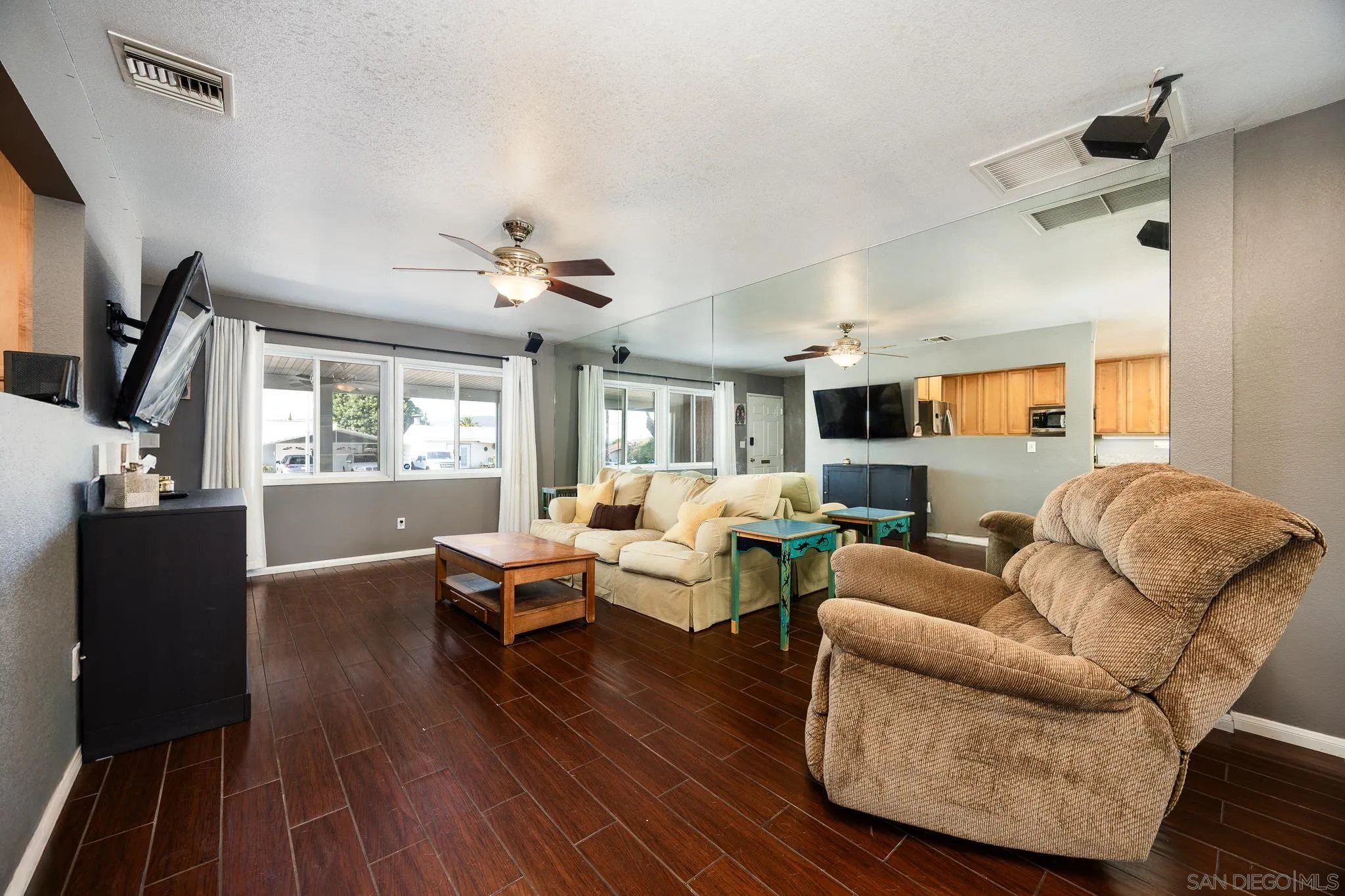 9276 Ruffin Road Santee, CA 92071 - Photo 11 of 40 a living room with furniture a large window and wooden floor