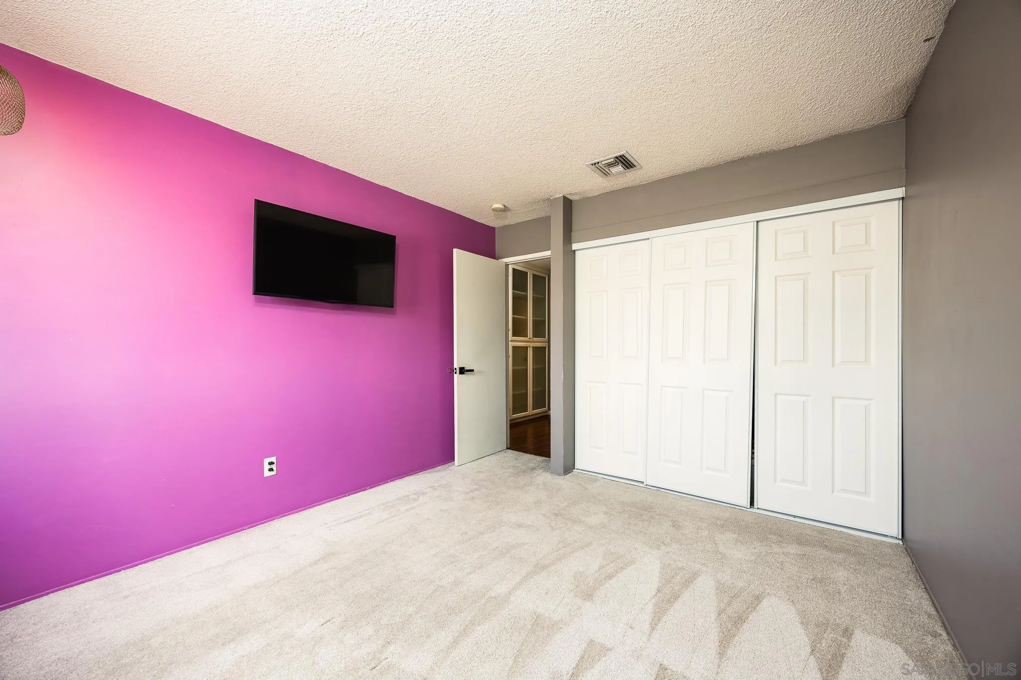 9276 Ruffin Road Santee, CA 92071 - Photo 20 of 40 a projector room with a bed and a flat screen tv