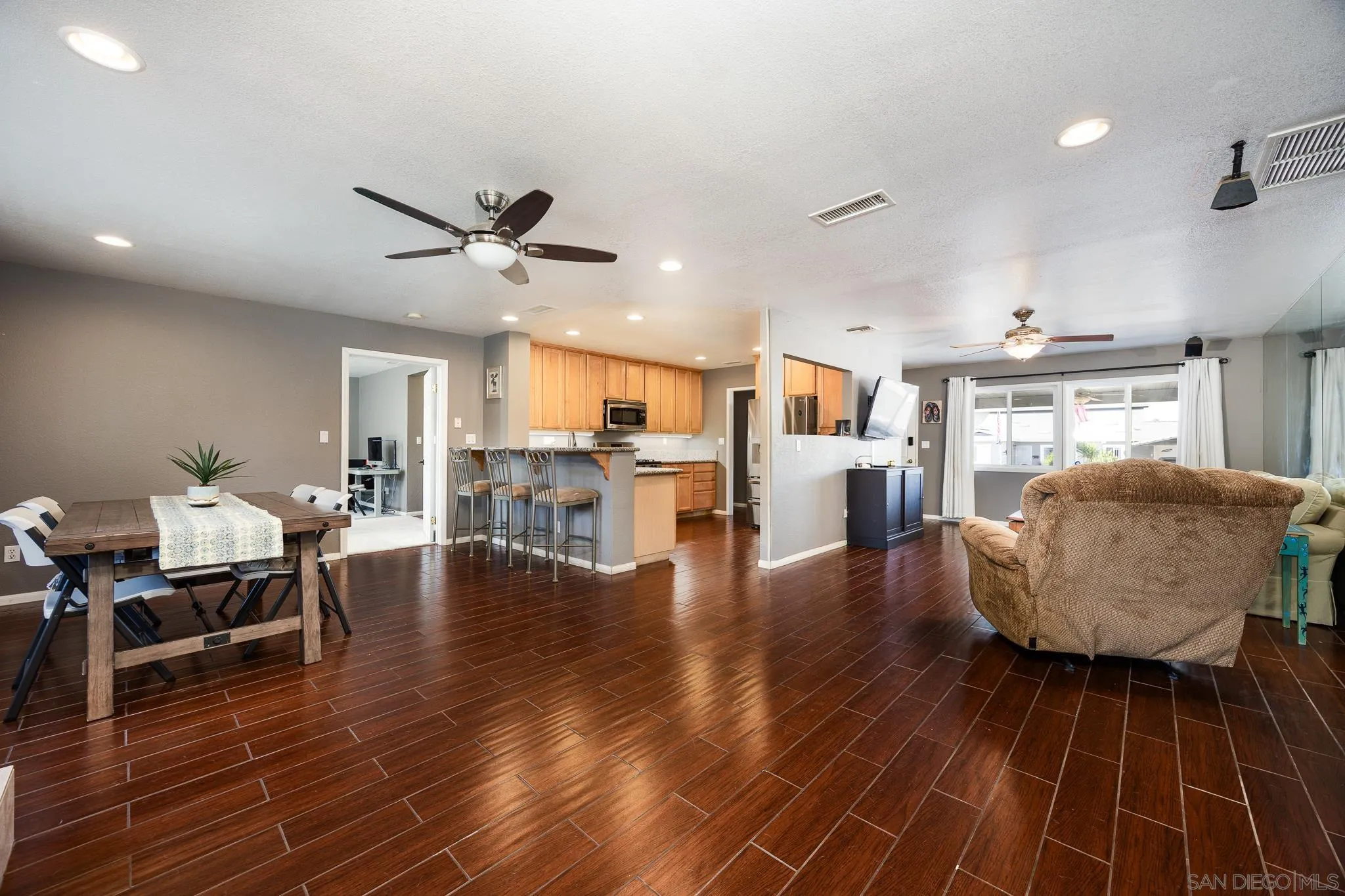 9276 Ruffin Road Santee, CA 92071 - Photo 5 of 40 a living room with furniture and wooden floor