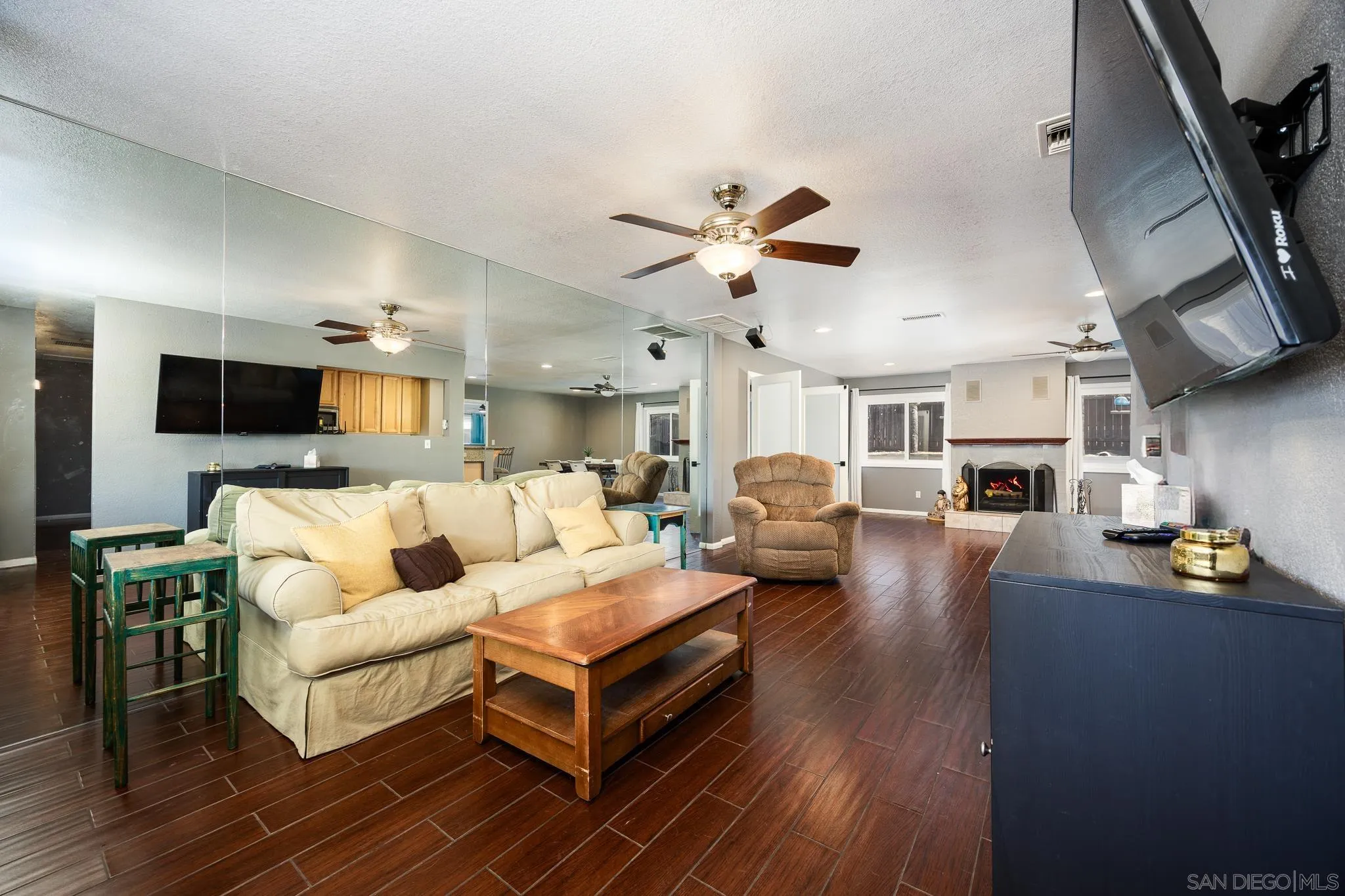 9276 Ruffin Road Santee, CA 92071 - Photo 10 of 40 a living room with furniture kitchen view and a wooden floor