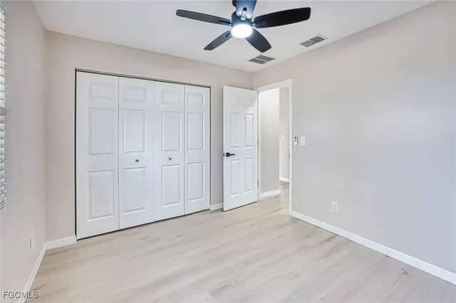 an empty room with a ceiling fan