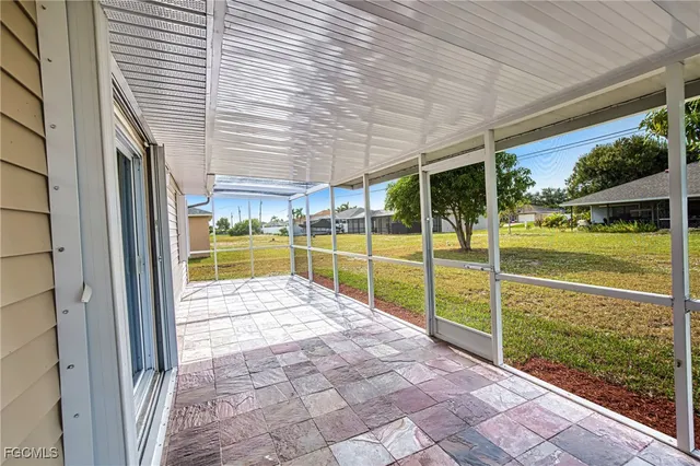 a view of a porch with a table and chairs