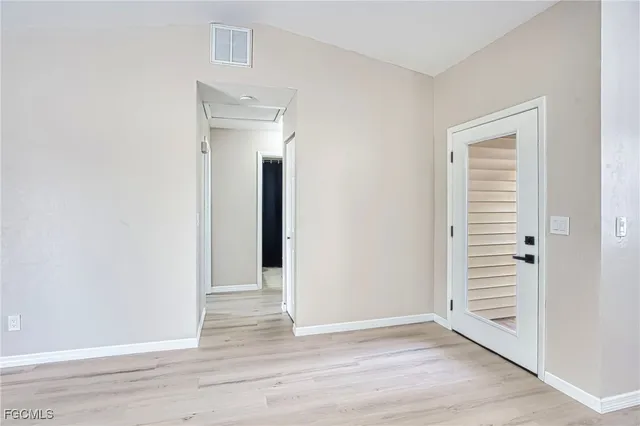a view of a room with wooden floor and closet