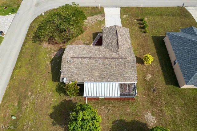 an aerial view of a house with garden space and lake view
