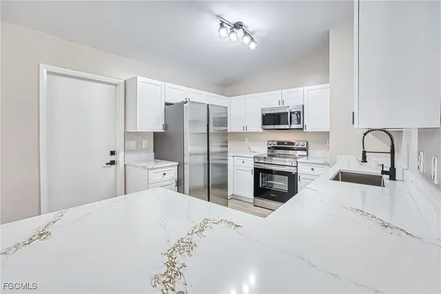 a kitchen with a stove a sink and a refrigerator