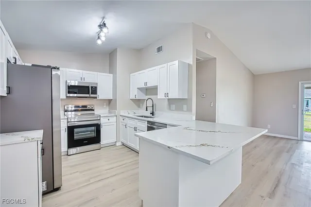 a kitchen with a refrigerator stove and sink