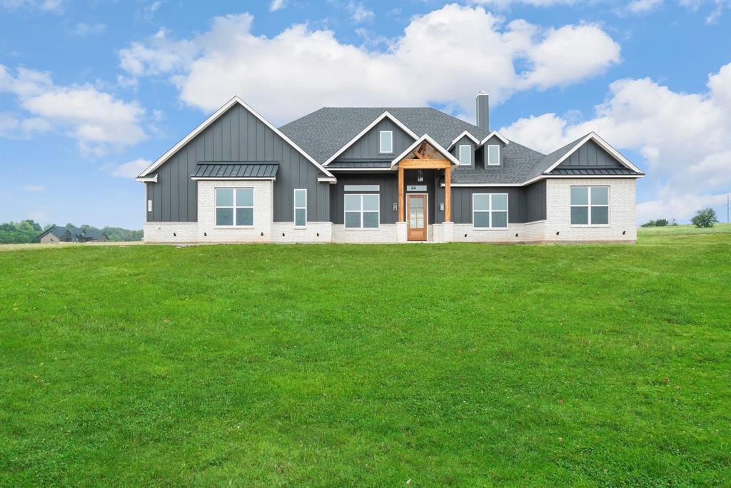 2041 Carrie Court Weatherford, TX 76088 - Photo 1 of 36 a front view of a house with a garden