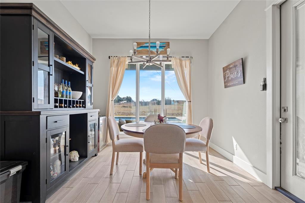 2041 Carrie Court Weatherford, TX 76088 - Photo 12 of 36 a view of a dining room with furniture window and wooden floor