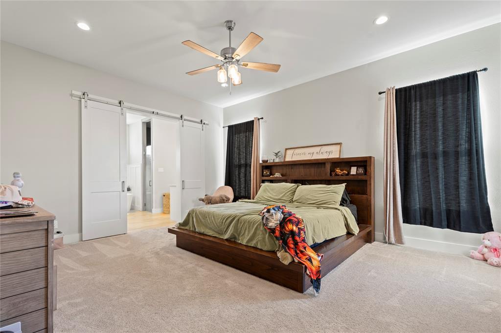 2041 Carrie Court Weatherford, TX 76088 - Photo 13 of 36 a bedroom with a bed and a chandelier