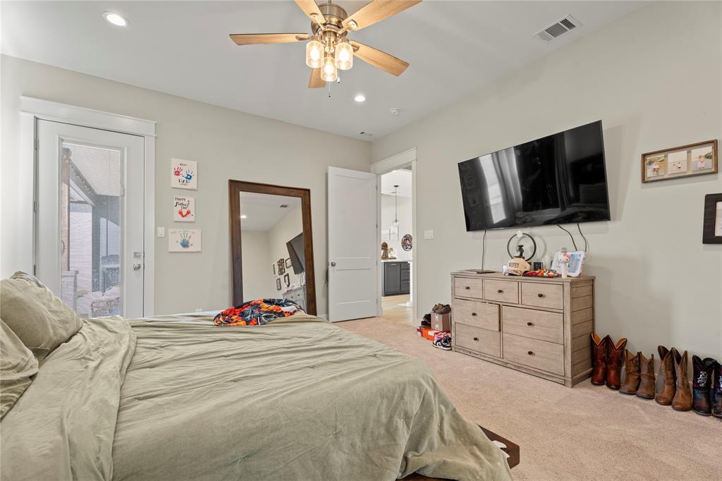 2041 Carrie Court Weatherford, TX 76088 - Photo 15 of 36 a bedroom with a bed and a flat screen tv