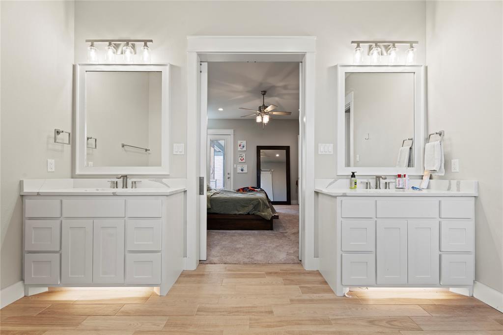 2041 Carrie Court Weatherford, TX 76088 - Photo 17 of 36 a en suite bathroom with a double vanity sink and a mirror