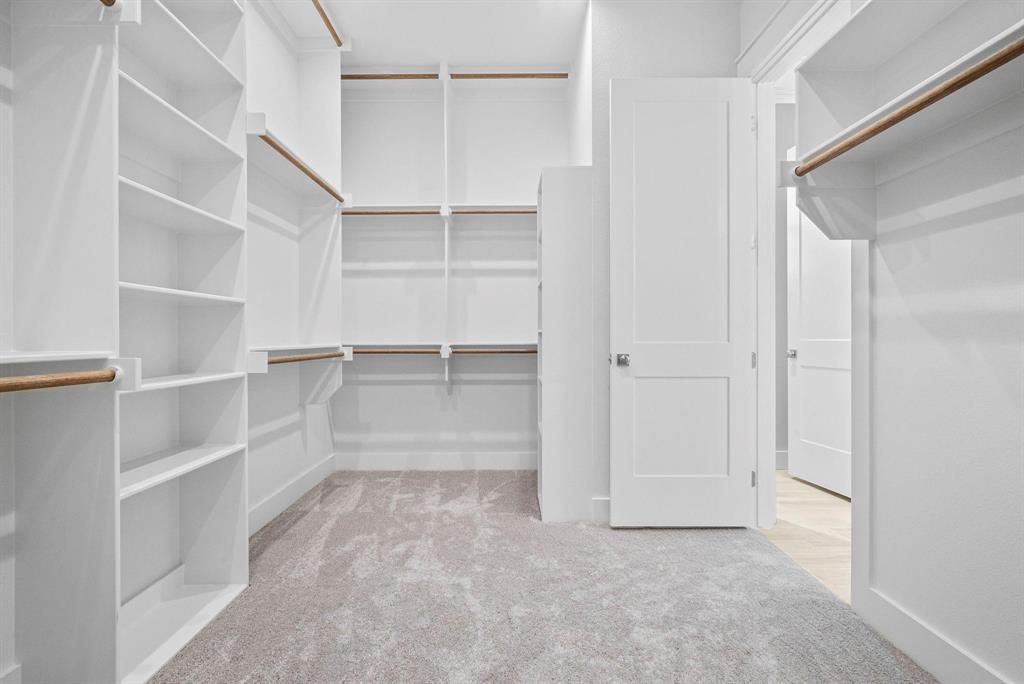 2041 Carrie Court Weatherford, TX 76088 - Photo 19 of 36 a view of walk in closet with empty racks