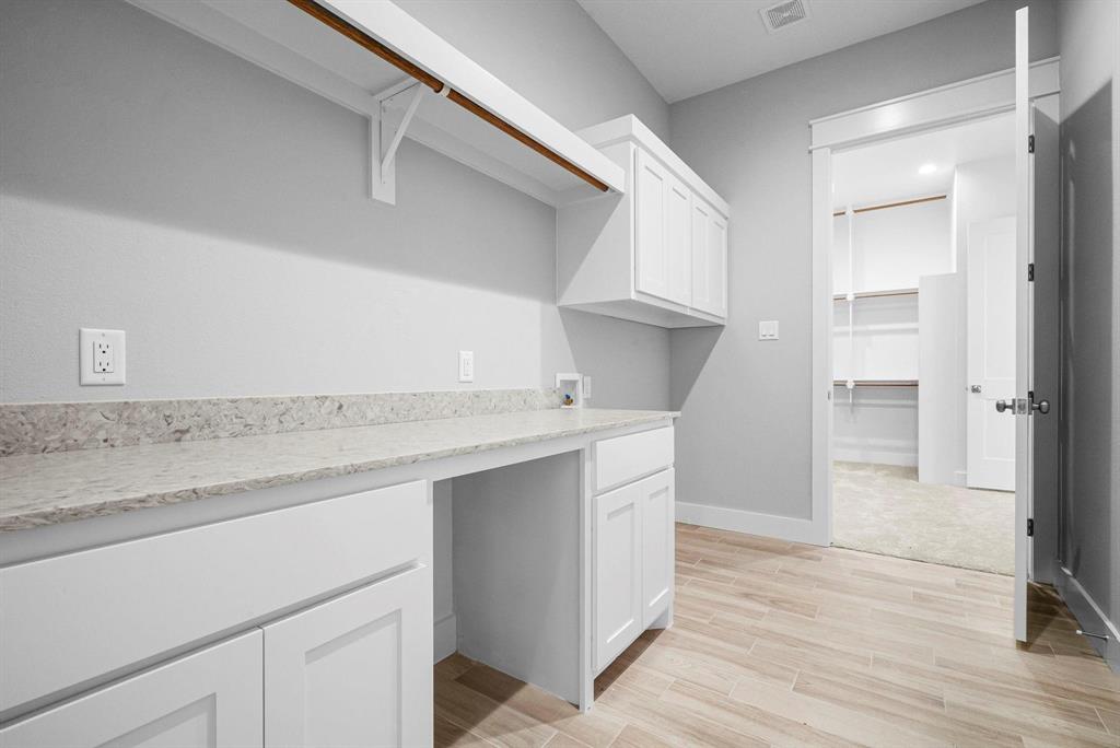 2041 Carrie Court Weatherford, TX 76088 - Photo 21 of 36 a kitchen with a sink cabinets and wooden floor
