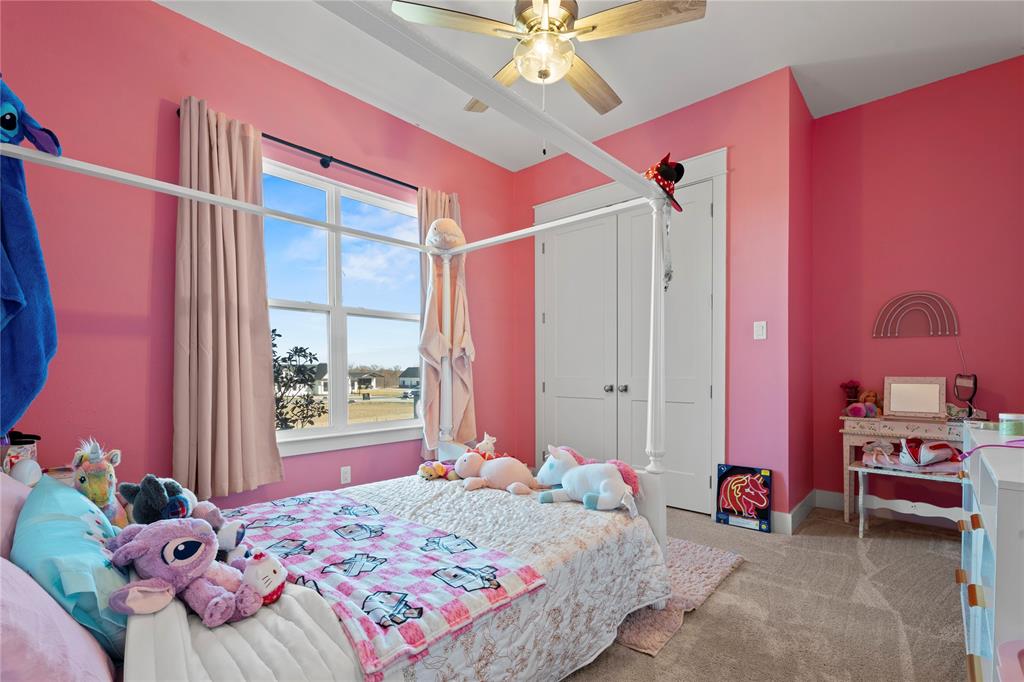 2041 Carrie Court Weatherford, TX 76088 - Photo 23 of 36 a bedroom with a bed dresser and a window