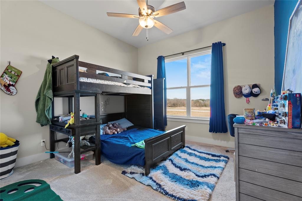 2041 Carrie Court Weatherford, TX 76088 - Photo 26 of 36 a living room with furniture and a fireplace