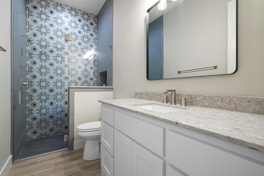2041 Carrie Court Weatherford, TX 76088 - Photo 28 of 36 a bathroom with a granite countertop toilet sink and mirror