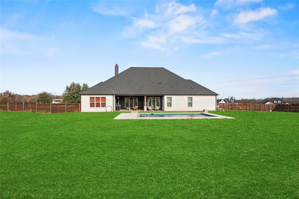 2041 Carrie Court Weatherford, TX 76088 - Photo 33 of 36 a view of a big house with a big yard and large trees