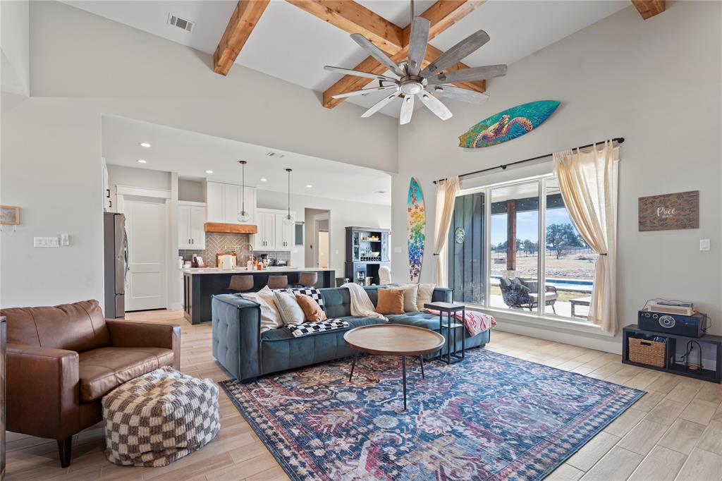 2041 Carrie Court Weatherford, TX 76088 - Photo 7 of 36 a living room with furniture a rug and a chandelier