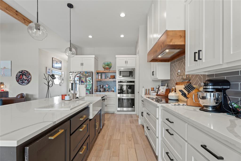 2041 Carrie Court Weatherford, TX 76088 - Photo 10 of 36 a kitchen with stainless steel appliances granite countertop a lot of counter space and cabinets